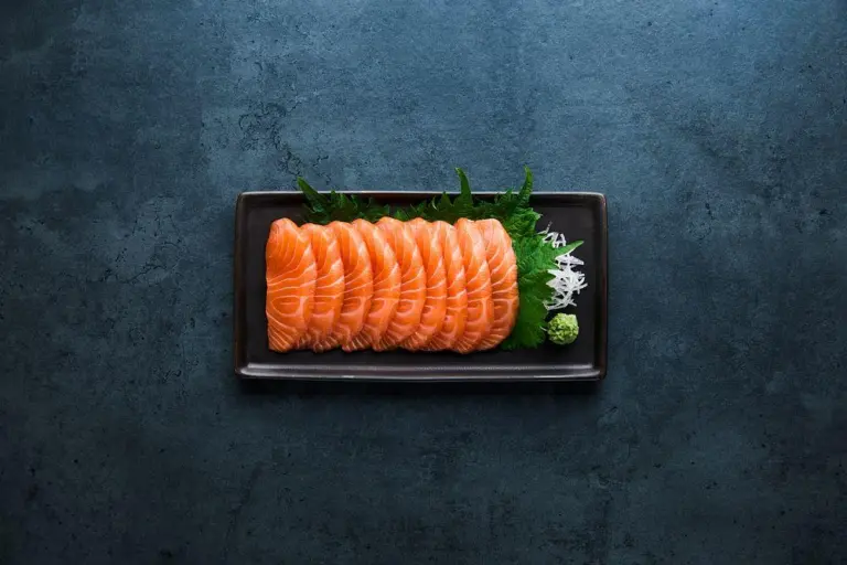 Sashimi laid on a black oblong plate