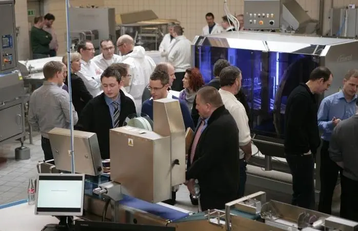 Executives from the international salmon processing industry examine Marel salmon processing equipment at last year’s Salmon ShowHow
