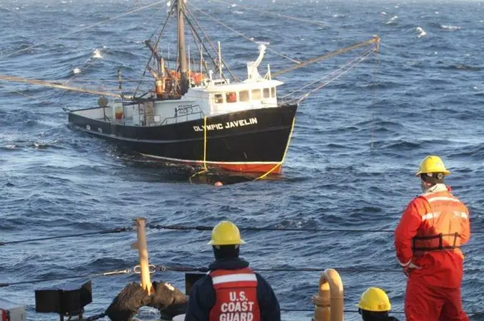 Coast Guard crew preparing to tow a disabled fishing vessel