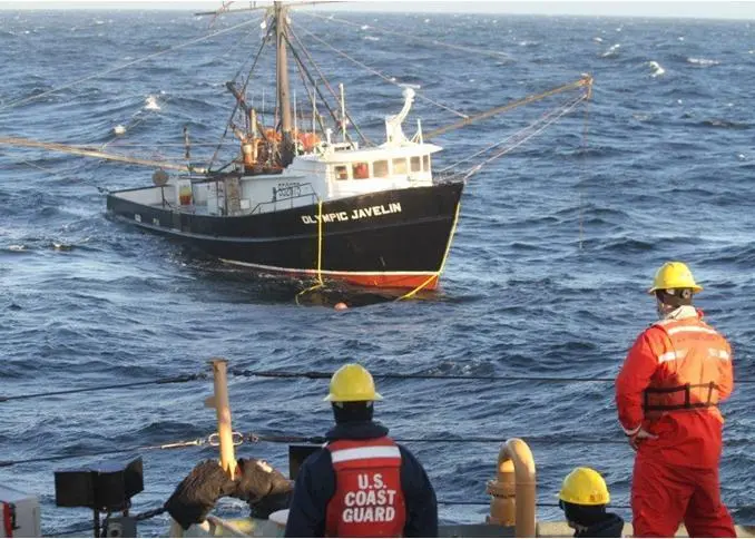Coast Guard crew preparing to tow a disabled fishing vessel