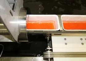 The egg vessels are passed horizontally into the pressure chamber