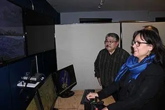Leona Aglukkaq, Minister of the Environment, Minister of CanNor, and Minister for the Arctic Council, operates the marine training simulator at Nunavut Arctic College