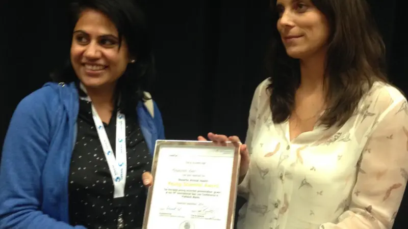 Marta Gameiro, Global Technical Services Manager for NAH Aqua, congratulates Kiranpreet Kaur on receiving the Young Scientist Award