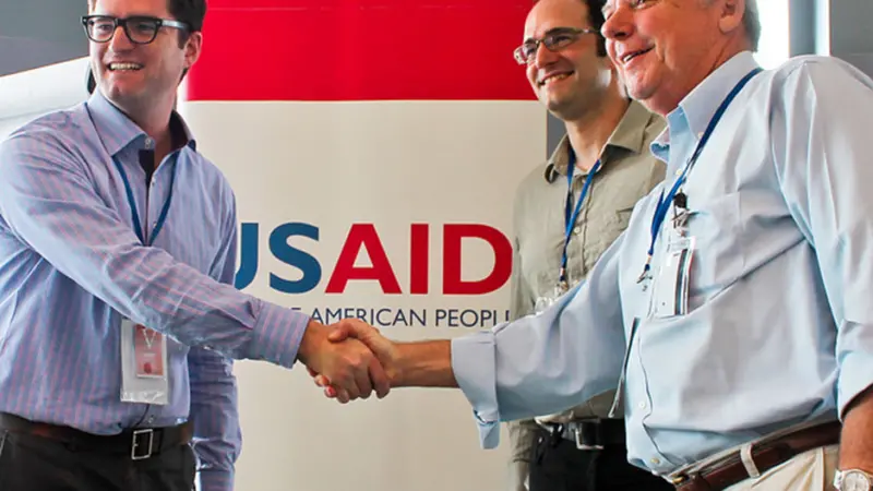 USAID Maximizing Agricultural Revenue through Knowledge, Enterprise Development and Trade project’s Chief of Party Tim Moore (left) congratulates Gerald Knecht, CEO of P.T. Bali Seafood (right) and David Solomon, CEO of Pelagic Data Systems. Credit: USAID