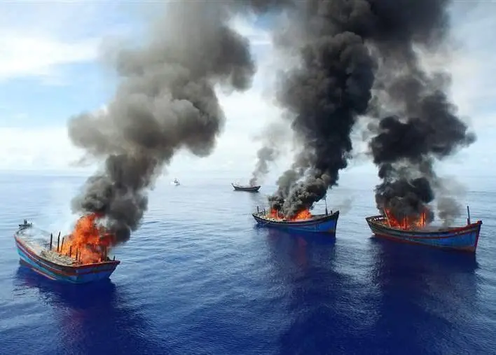 Four Vietnamese Blue Boat vessels burn on June 12 after Palau authorities caught them fishing illegally. © Jeff Barabe for The Pew Charitable Trusts