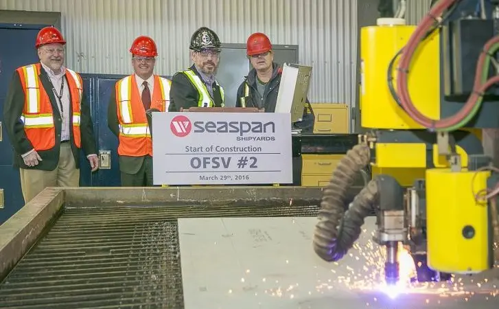 Employees at Vancouver Shipyards witness the first cut of steel