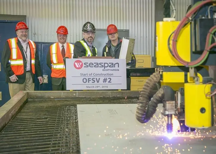 Employees at Vancouver Shipyards witness the first cut of steel