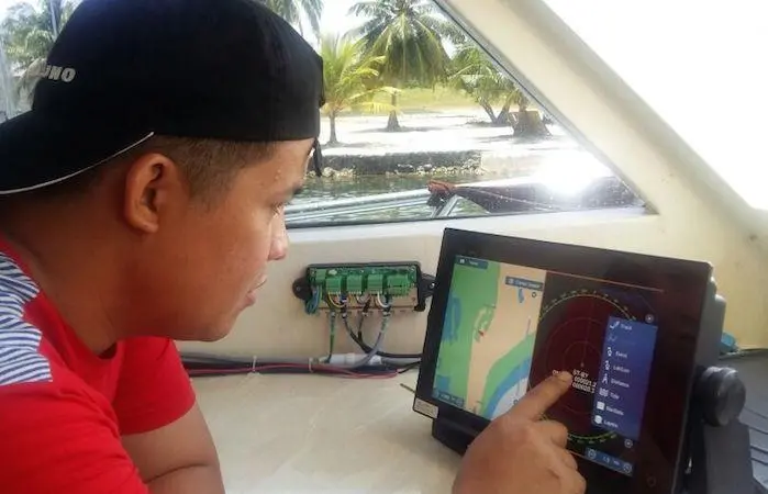 One of Julie’s crew with the bird-tracking radar supplied by Furuno