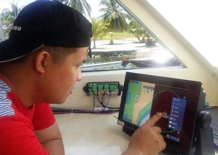 One of Julie’s crew with the bird-tracking radar supplied by Furuno