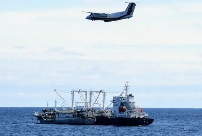 Canadian patrol aircraft overflying a fishing vessel and a carrier vessel on the high seas of the North Pacific Ocean. Photo: DFO