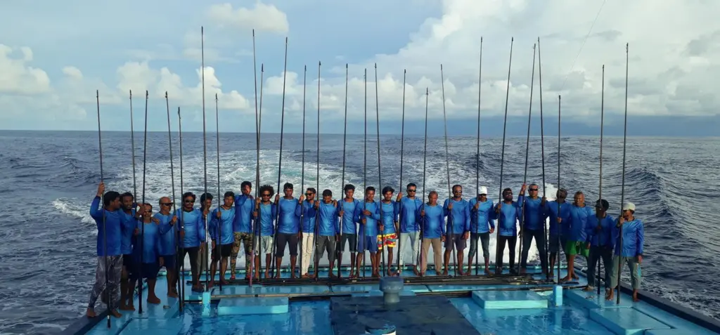 One-by-one tuna fishers standing on a fishing vessel at sea