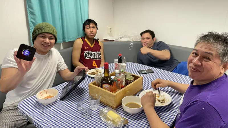 Fishers on board accessing the internet whilst enjoying a meal