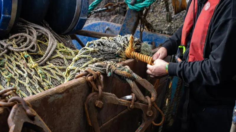 Fisherman mending a net