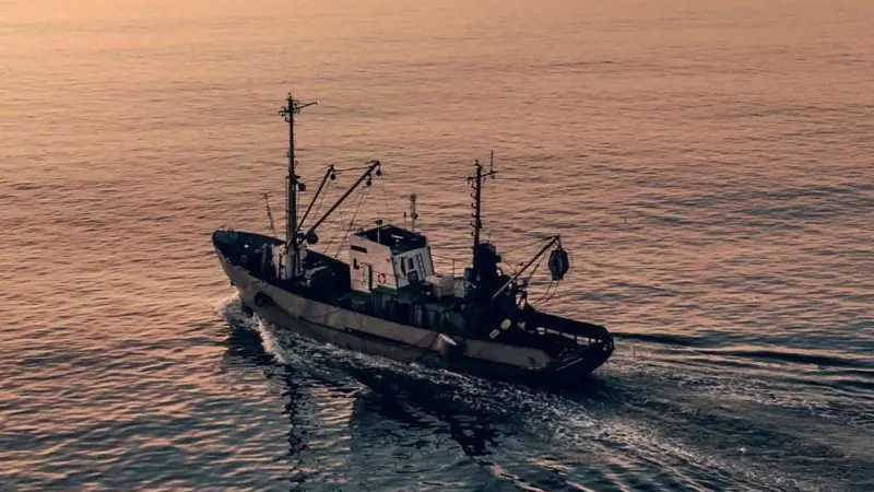 EU fishing boat at sunset