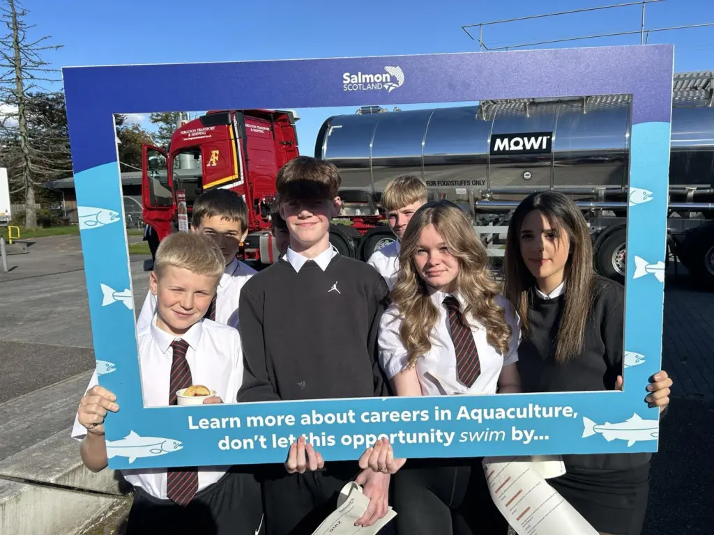 Pupils hold a selfie frame in front of a Fergusons Transport tanker
