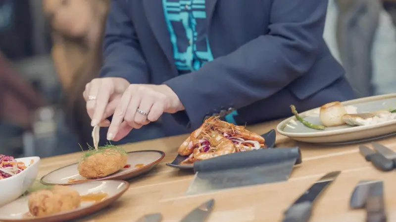 Someone cutting into seafood at the UK Seafood School in Grimsby