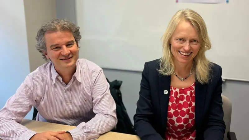Nicolas Guichoux, chief programme officer at MSC, and Libby Woodhatch, executive chair at MarinTrust sitting at a desk during an MoU signing