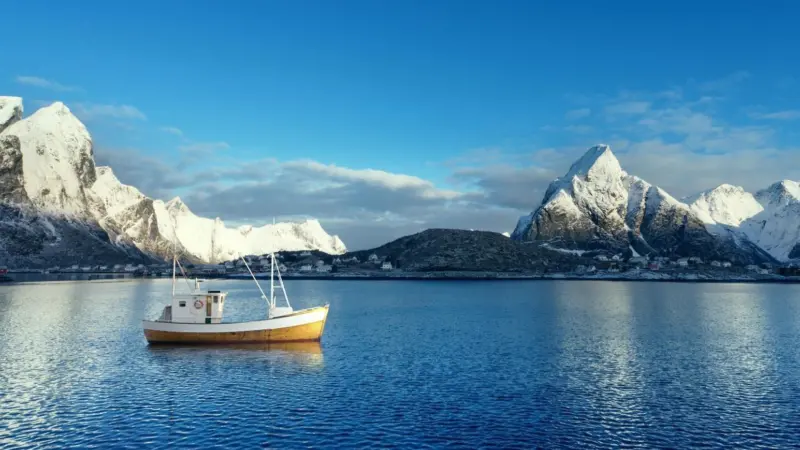 Fishing boat and Reine Village, Lofoten Islands, Norway