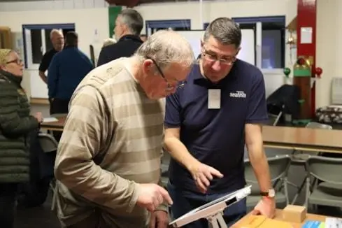 Two men using the Kingfisher Bulletin safety app
