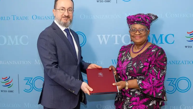 The image shows Mr. Burim Bilali, Acting Permanent Representative, presenting North Macedonia’s instrument of acceptance to WTO, director-general Ngozi Okonjo-Iweala.