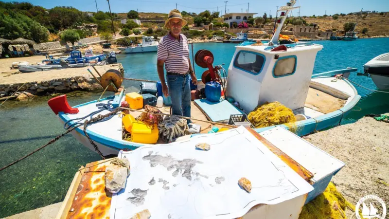 Fisherman stood on the deck of his small fishing boat in the eastern Aegean Sea