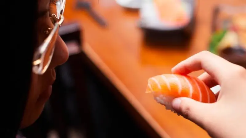 A picture of Norwegian salmon being consumed as sushi