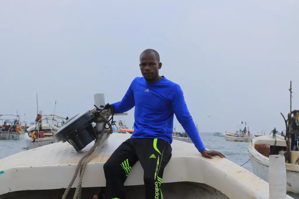 Member of Project Recon sat on board a boat with a recovered echosounder buoy