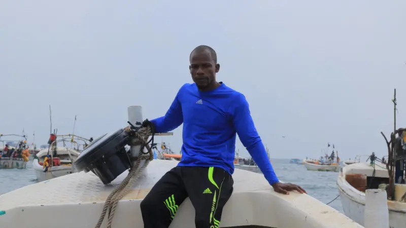 Member of Project Recon sat on board a boat with a recovered echosounder buoy