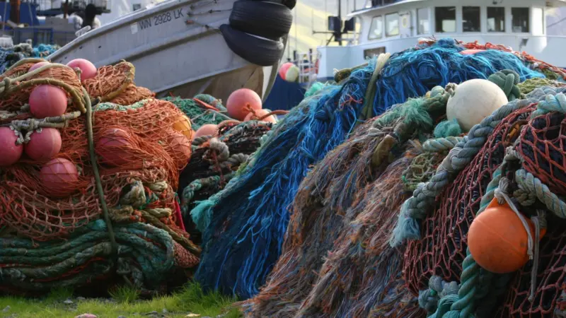 Fishing vessel surrounded by nets